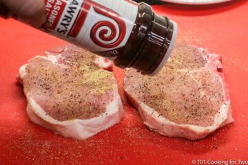 sprinkling seasoning salt on pork chops