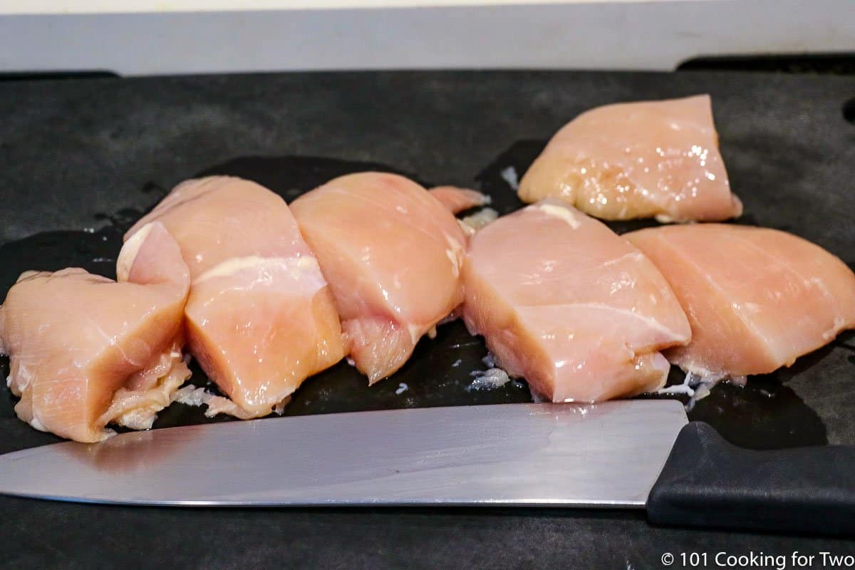 Chicken breasts trimmed into chunks.