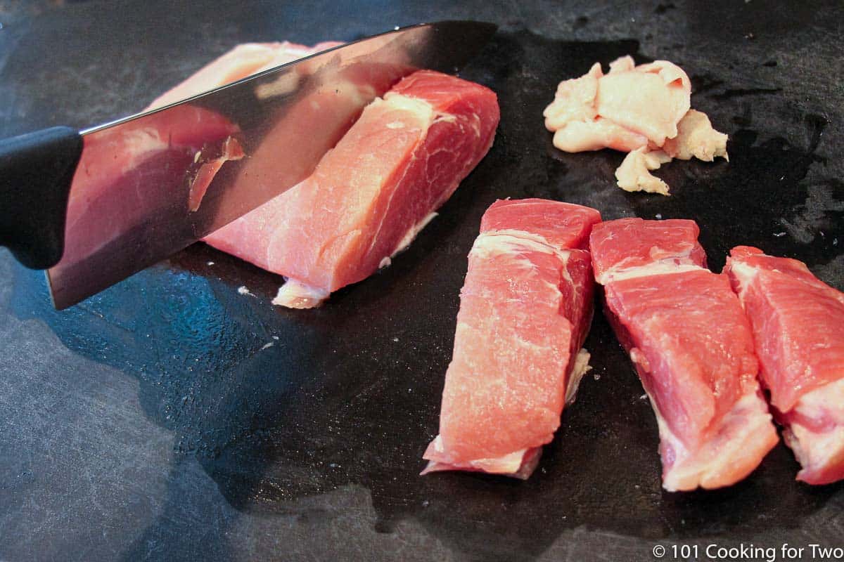 cutting boneless pork ribs into single ribs.