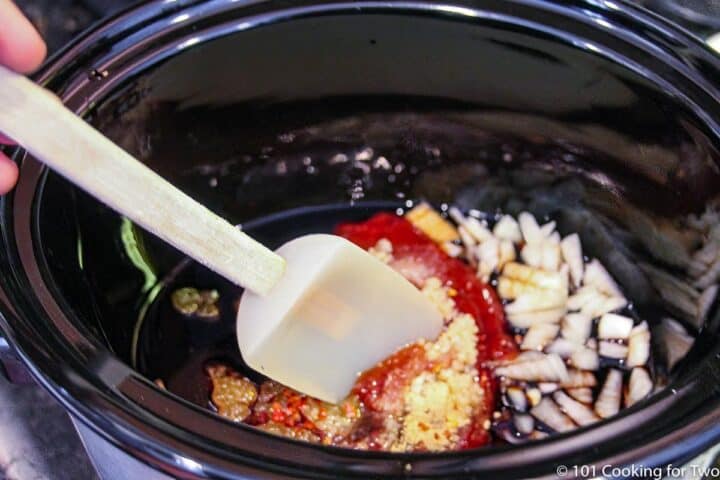 mixing sauce ingredients in a crock pot