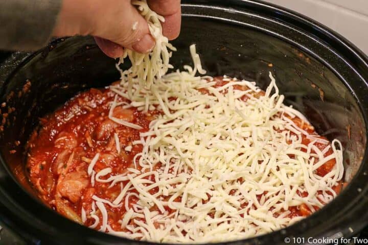 topping the crock pot with cheese