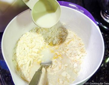 adding milk into dry ingredients