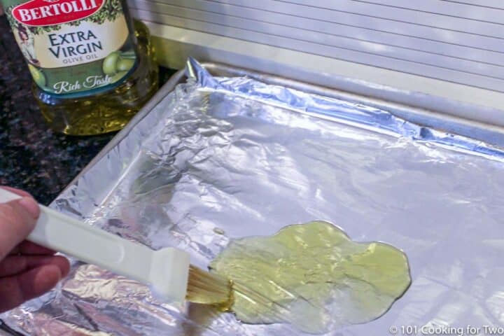 brushing oil on baking tray