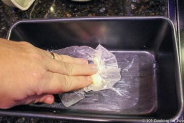 coating a loaf pan with butter