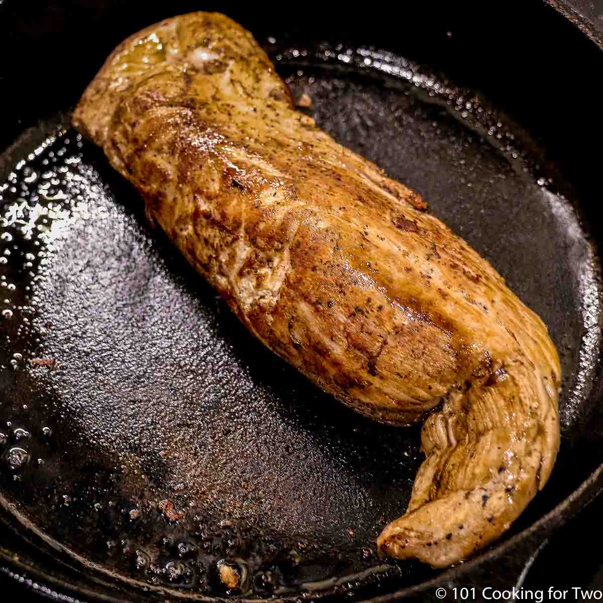 cooked pork tenderloin in a cast iron skillet.