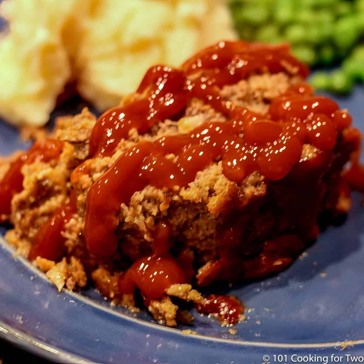 meatloaf with ketchup on a blue plate