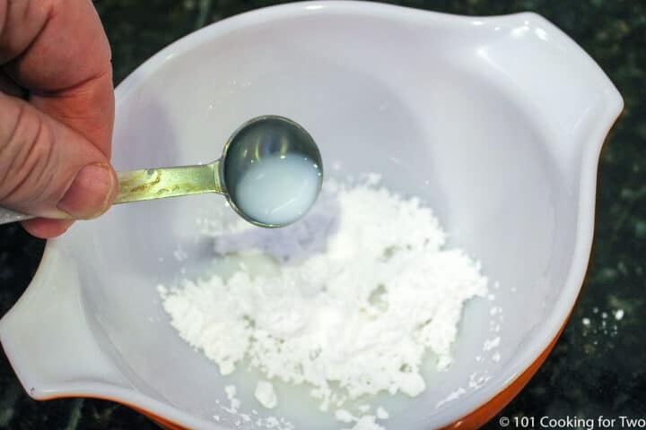 mixing glaze in a white bowl