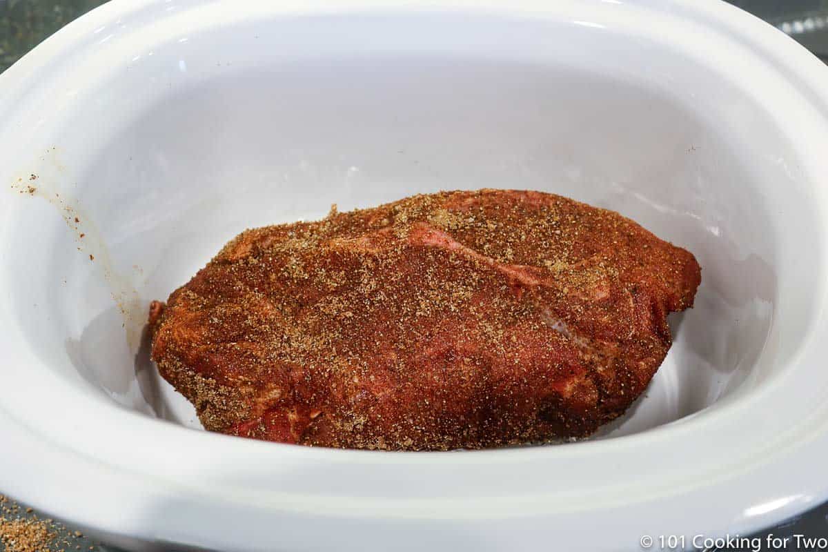 pork butt on foil balls in a crock pot.