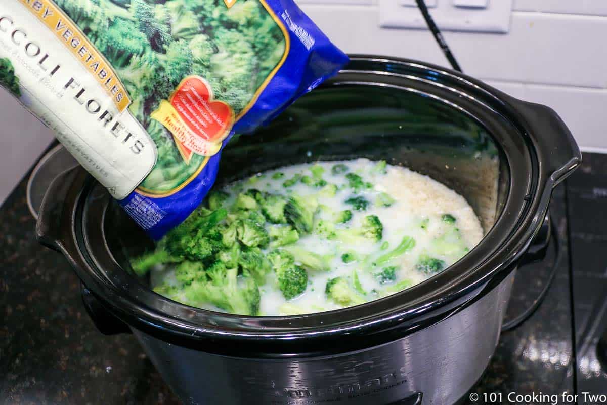 pouring frozen broccoli into the crock pot.