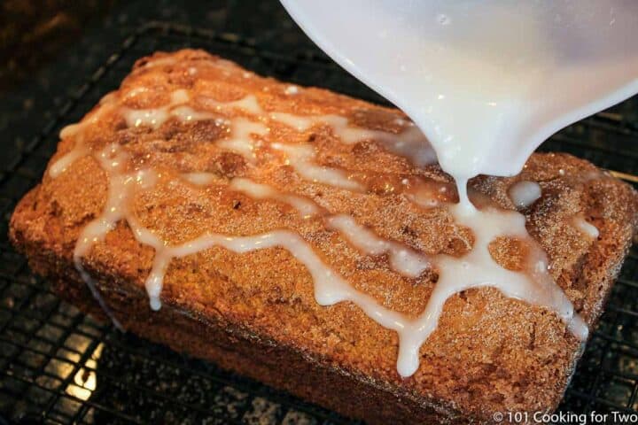 pouring glaze over cinnamon bread