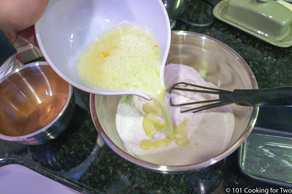 pouring wet ingredients into dry ingredients.