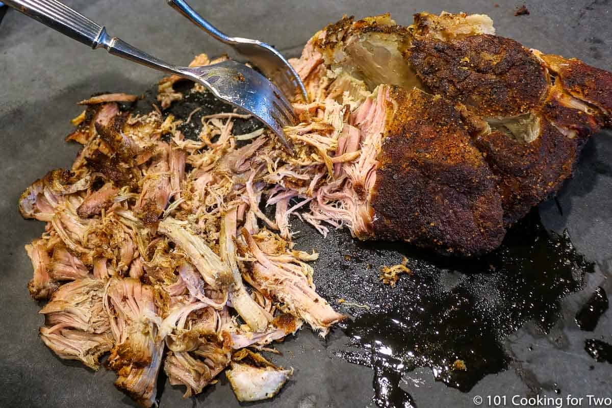 shredding pulled pork with forks.