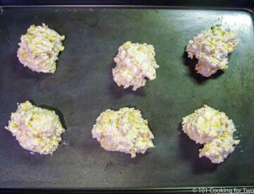 six raw biscuits on a sheet pan