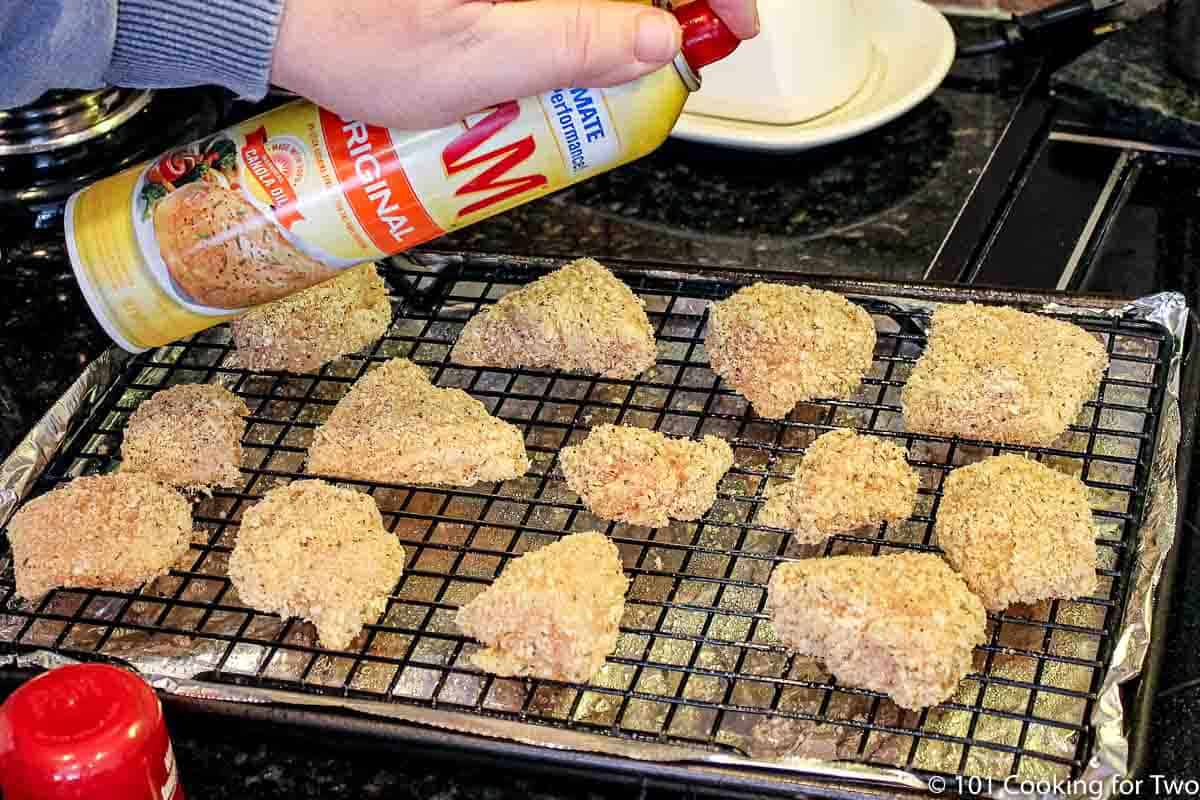 spraying breaded nuggets with PAM
