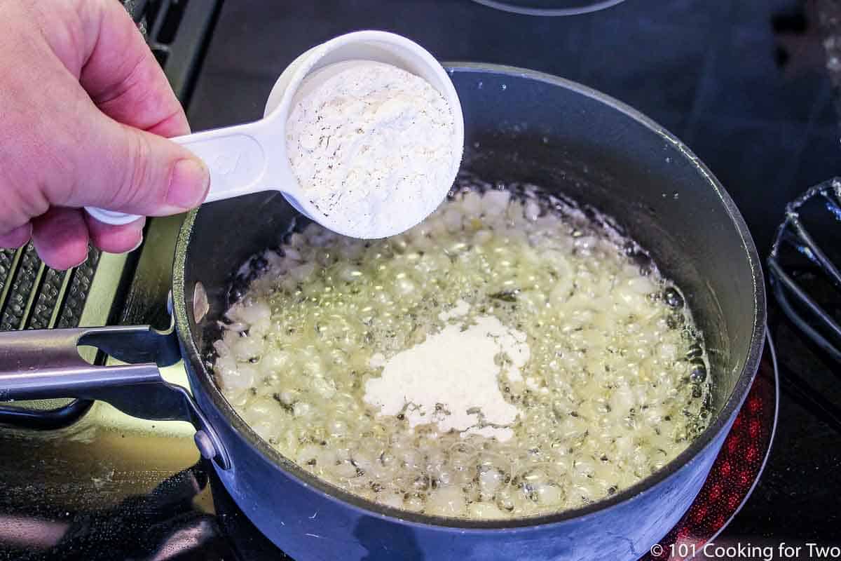 sprinkling flour into cooked onion and butter to make roux