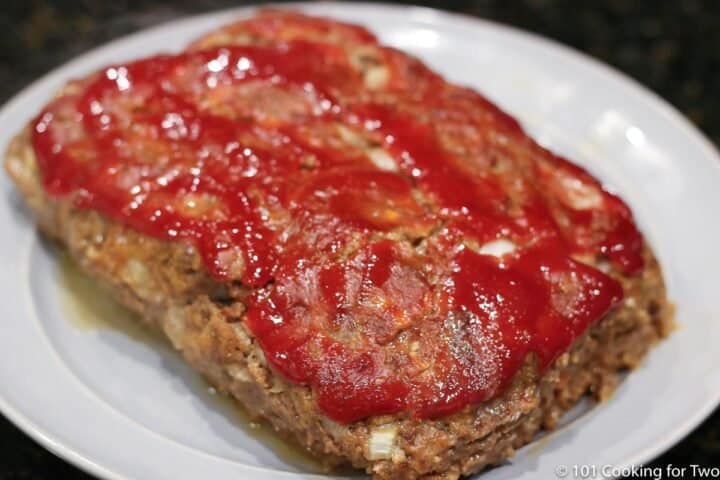 cooked meatloaf on a white plate