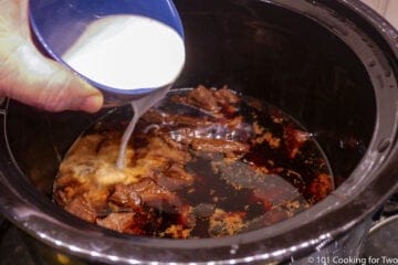 adding a corn starch slurry to the cooked meat