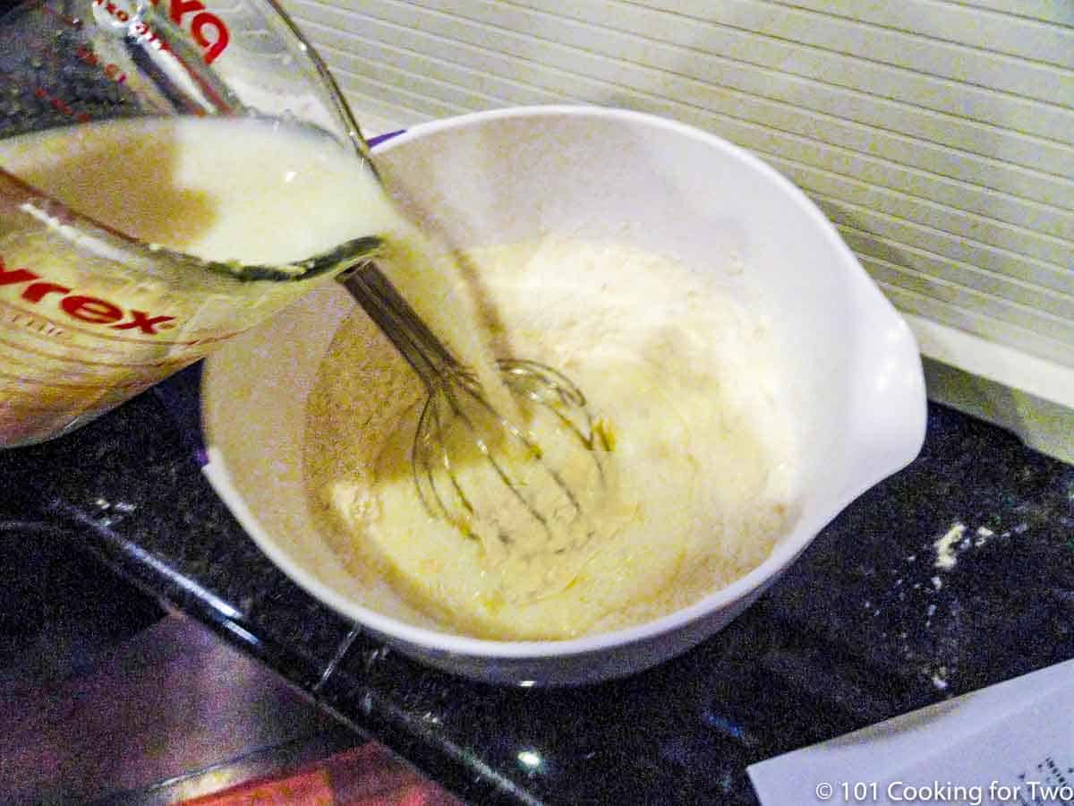 adding wet ingredients into dry ingredients