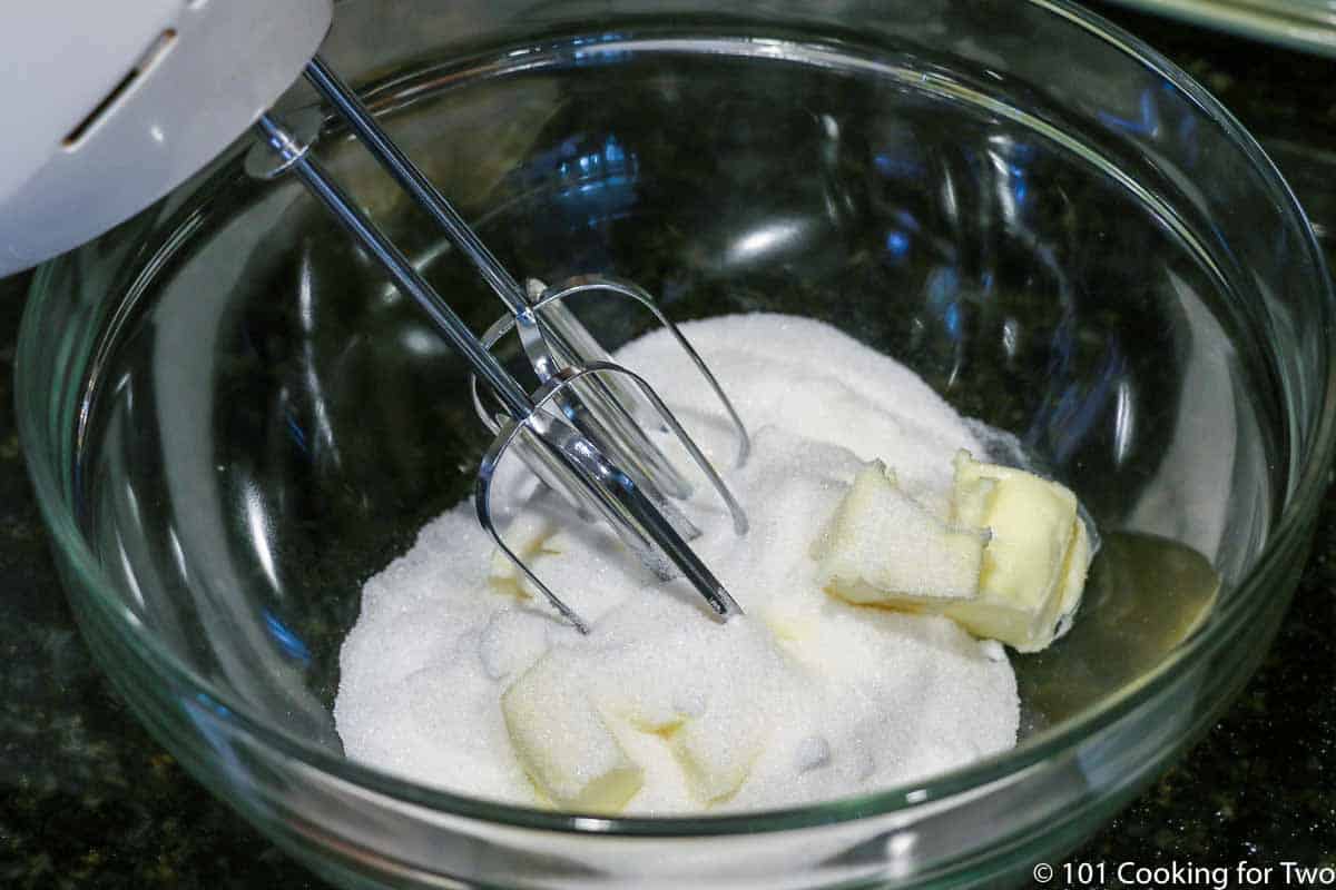 bowl with sugar and butter and mixer ready to beat