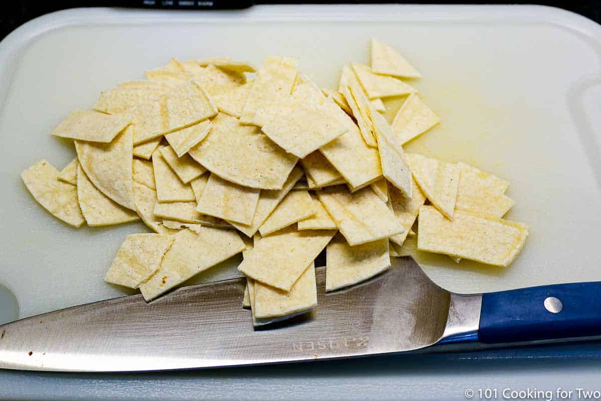 chopped tortillas on a white board.