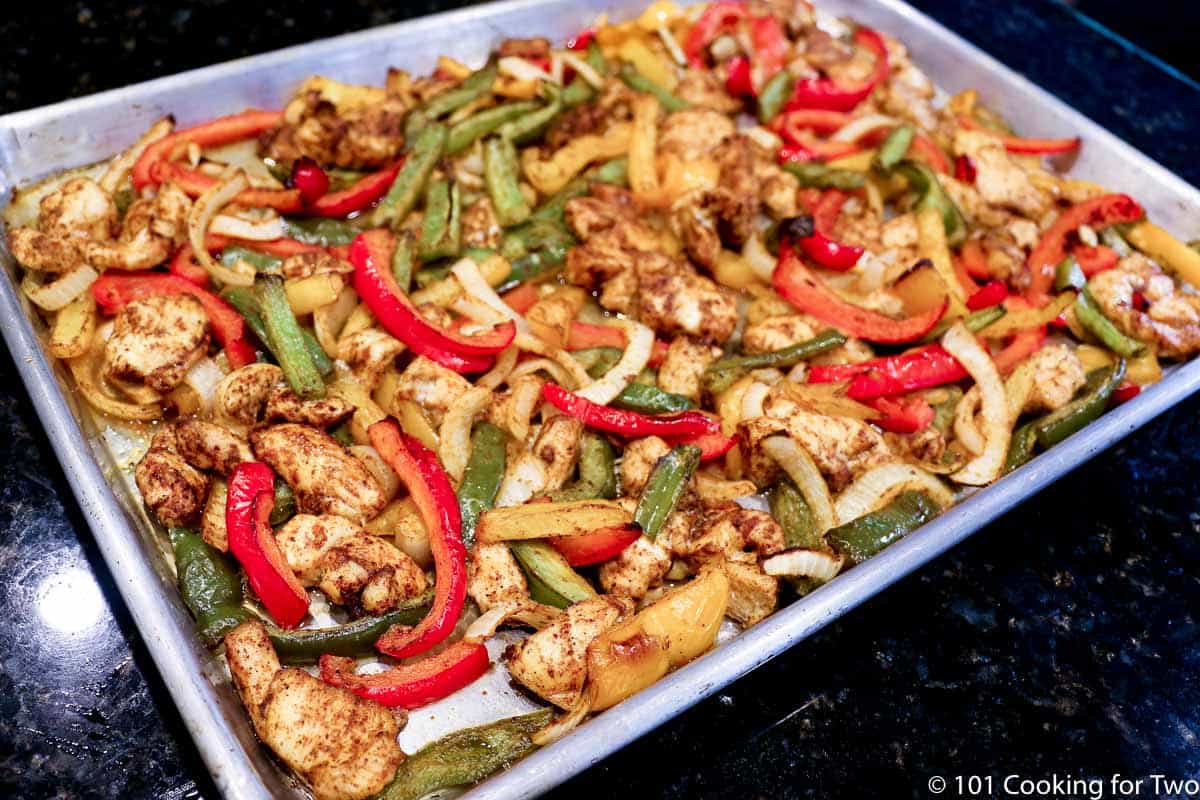 cooked chicken fajitas on sheet pan.