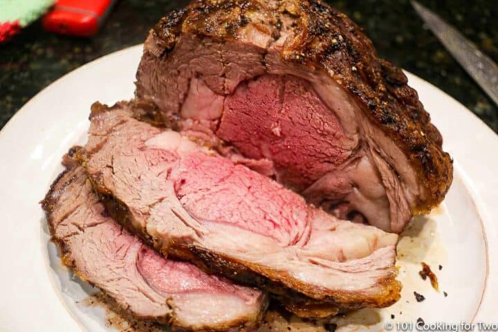 cut ribeye roast on a white plate