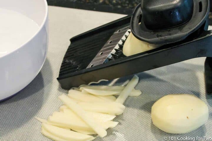 cutting potatoes with a mandolin B