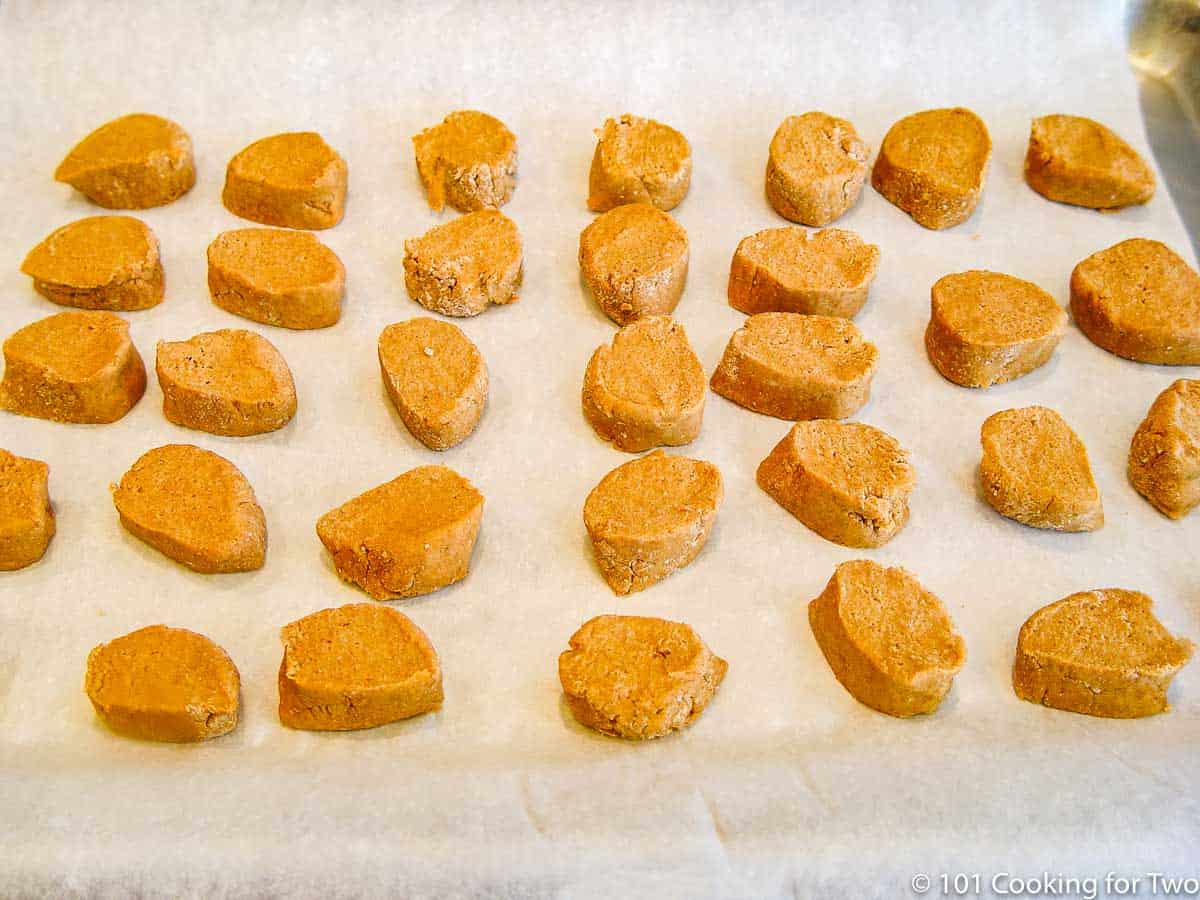 dog biscuts spread over parchment paper.