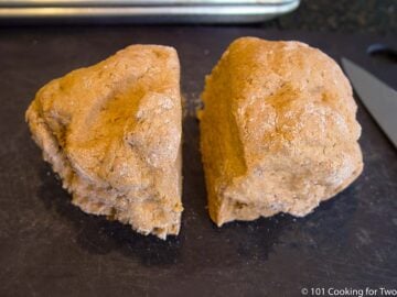 dough in two pieces on a black board