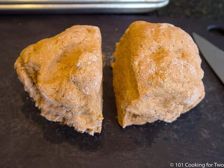 dough in two pieces on a black board