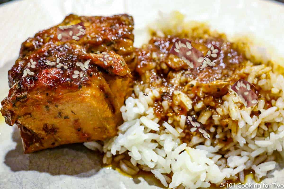 honey garlic chicken with rice on a white plate wide view