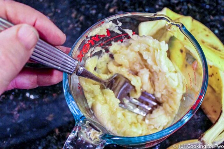 mashing bananas in a measuring cup