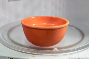 orange cup in a microwave