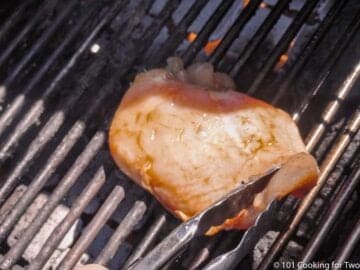 placing chicken breast on the grill