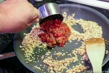 pouring salsa into browned rice