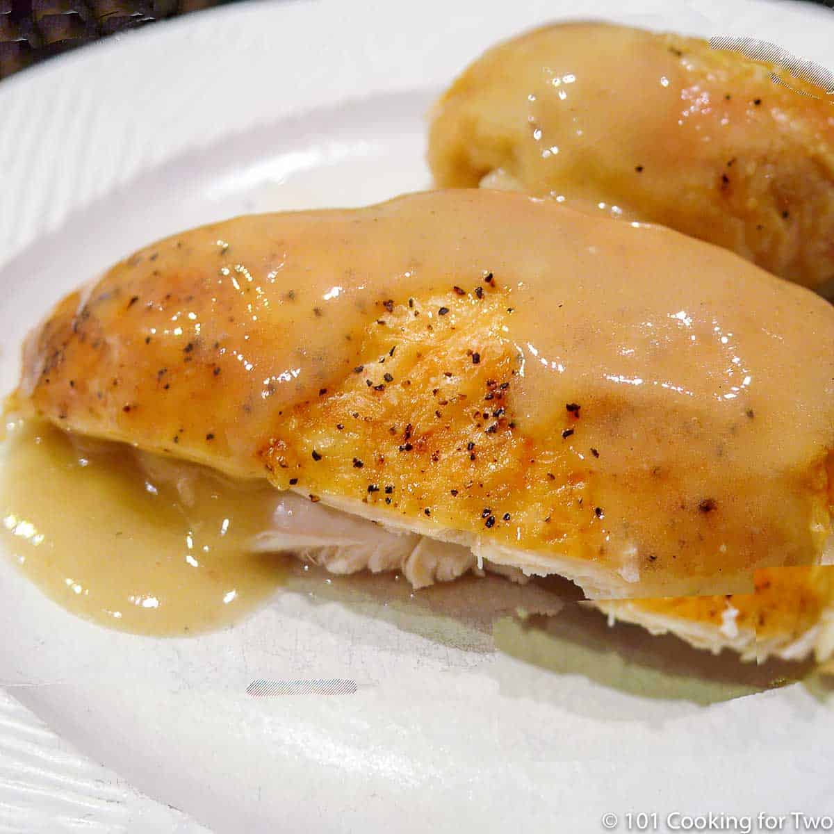 roasted chicken with gravy on white plate
