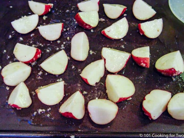 speading cut potatoes over sheet pan