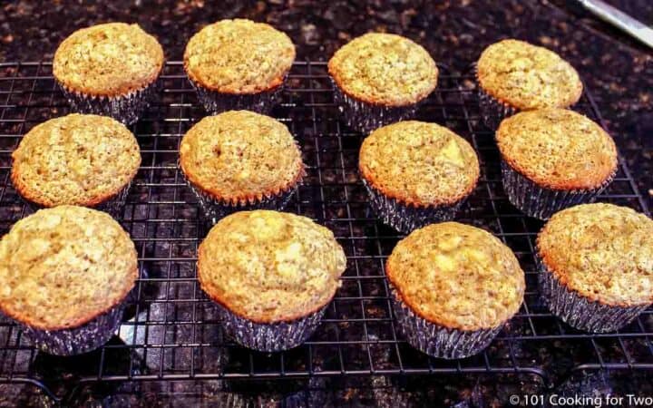 twelve baked muffins on a wire rack