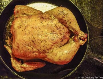 whole roasted chicken cooked in skillet wide view