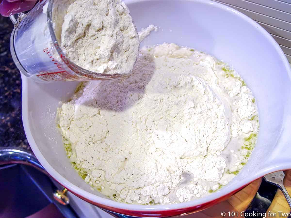 adding flour to the yeast liquid