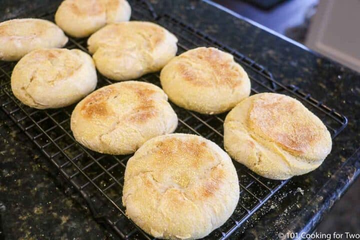 baked English muffins on a cooling rack.