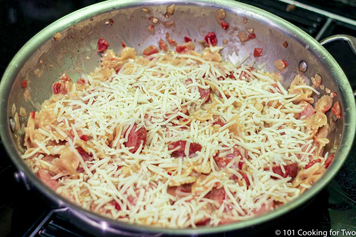 cheese topping the pasta ready for the oven.