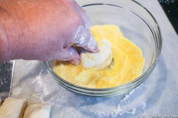 coating dough in yellow corn meal