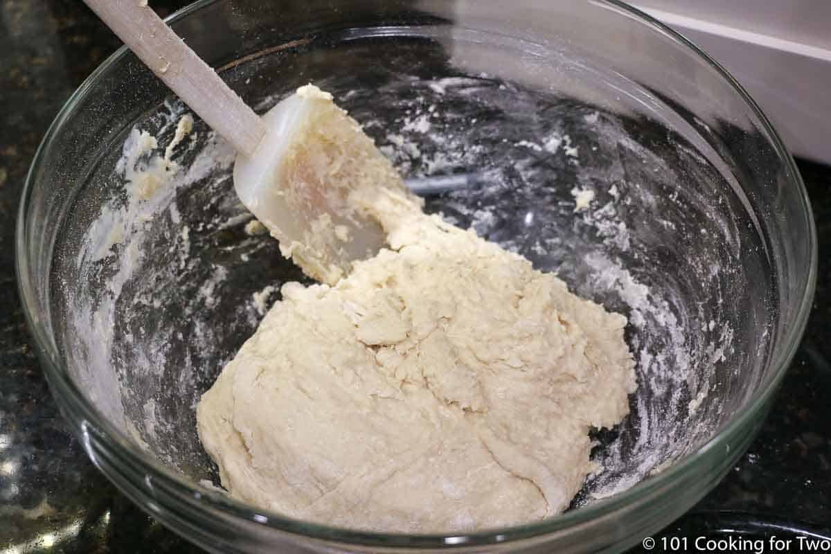forming the dough into a ball in a the bowl.