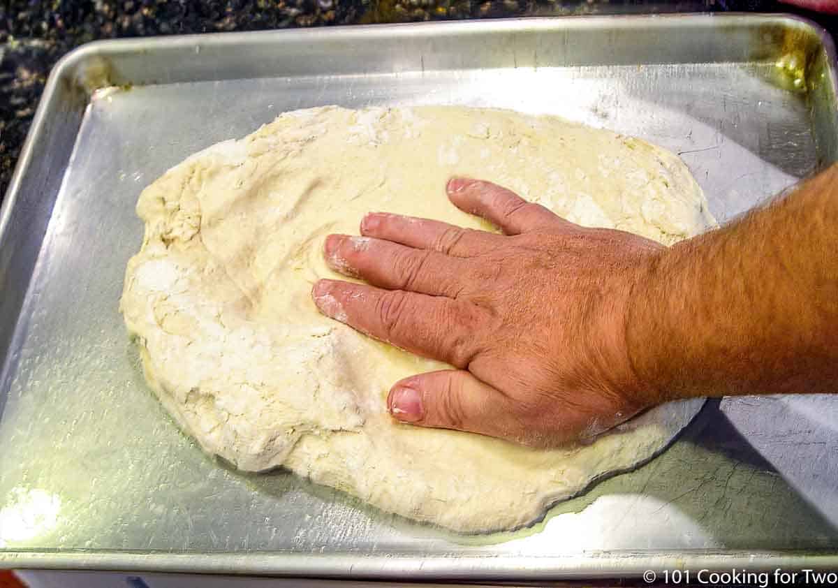 making out pizza dough on a sheet pan