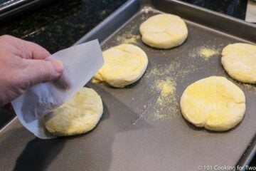moving raw muffins to heated baking sheet
