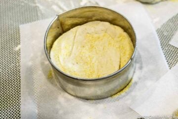 raw dough in baking ring on a piece of parchment paper
