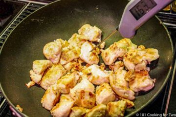 Cooked chicken in black skillet