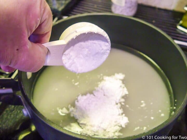 adding cornstarch to pan with sugar and water