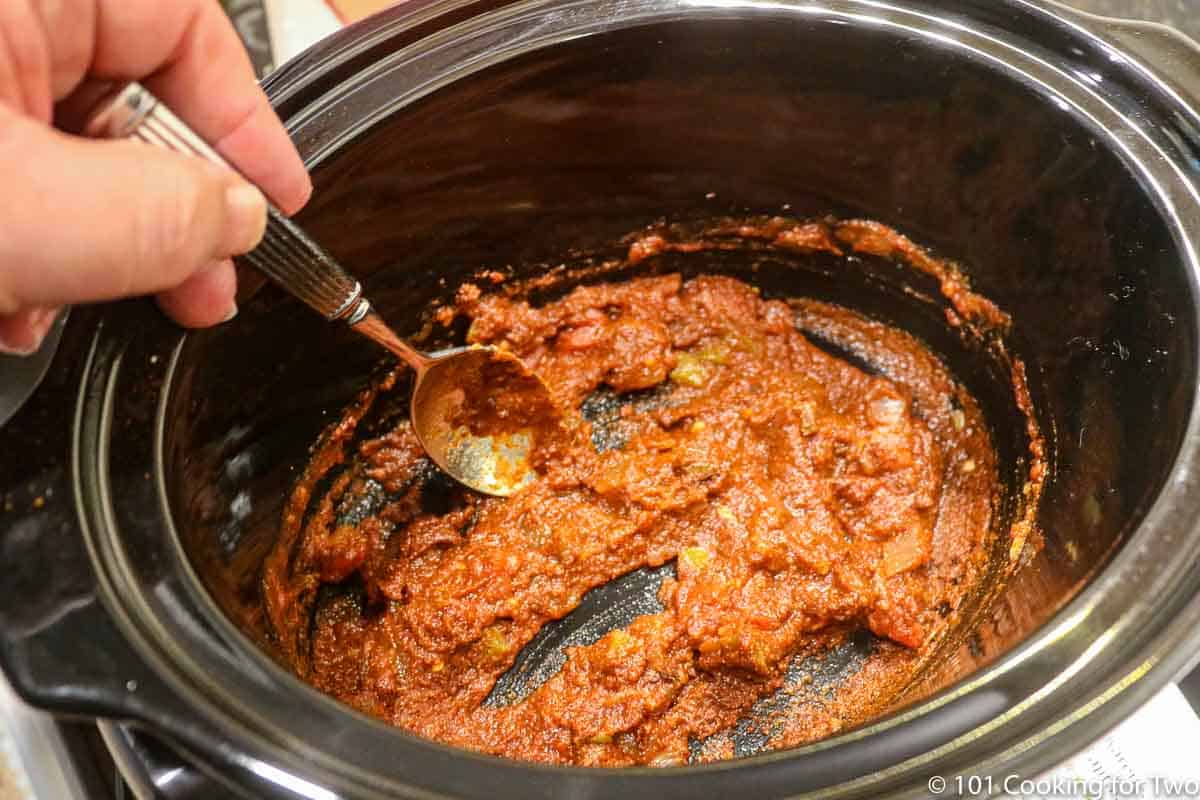 Mixing sauce in the crock pot.